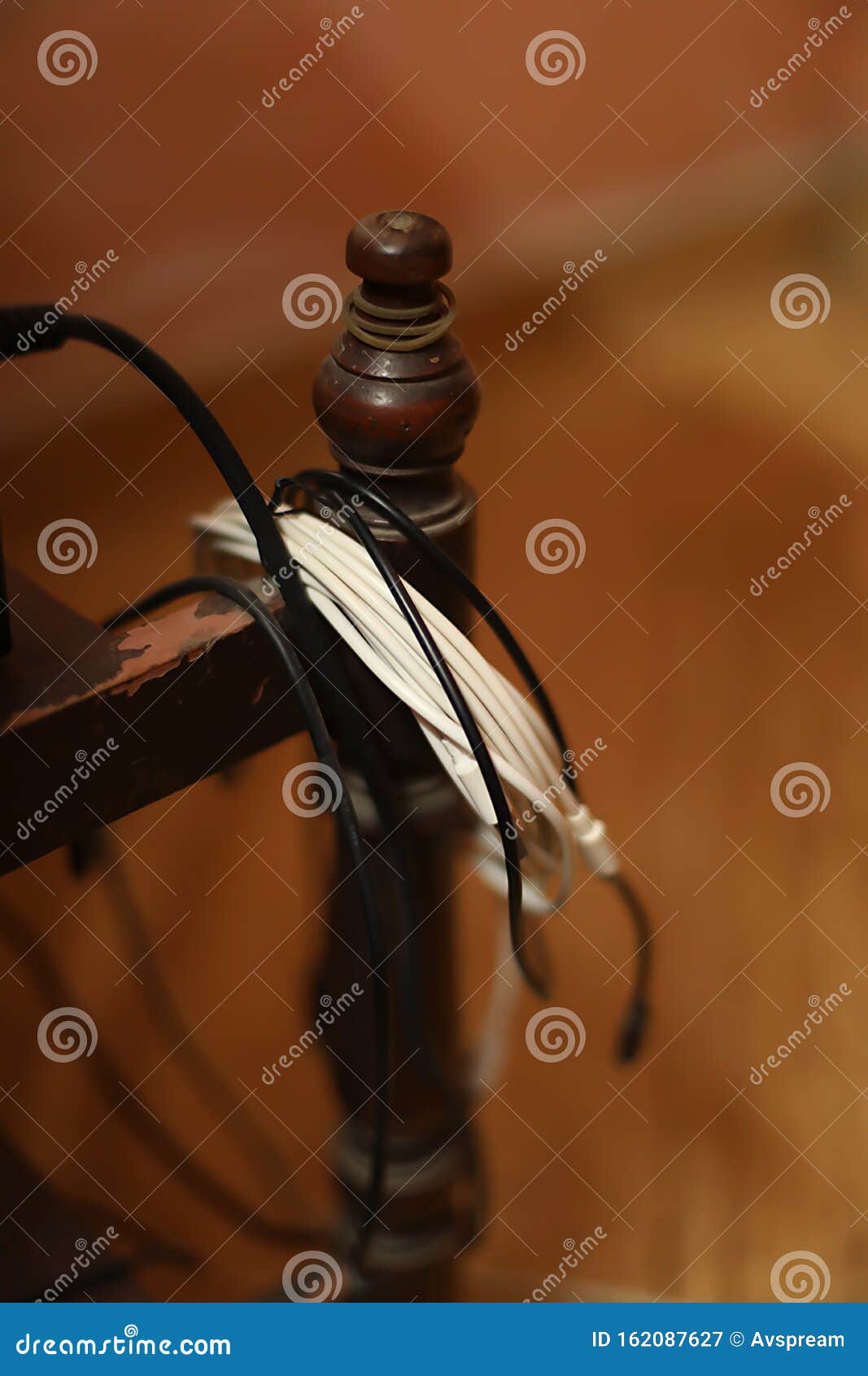 Smartphone Cable or Broken Phone Cable Hangs on Desk Stock Image