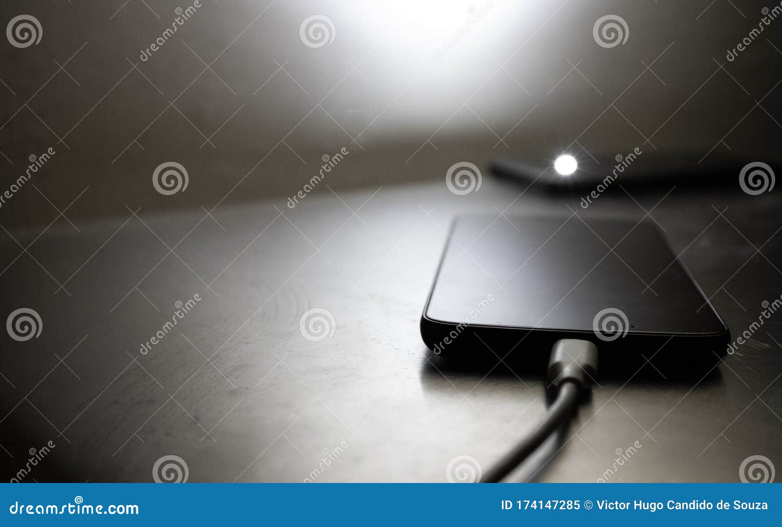 Smartphone Charging The Battery On A Desk Stock Image Image Of