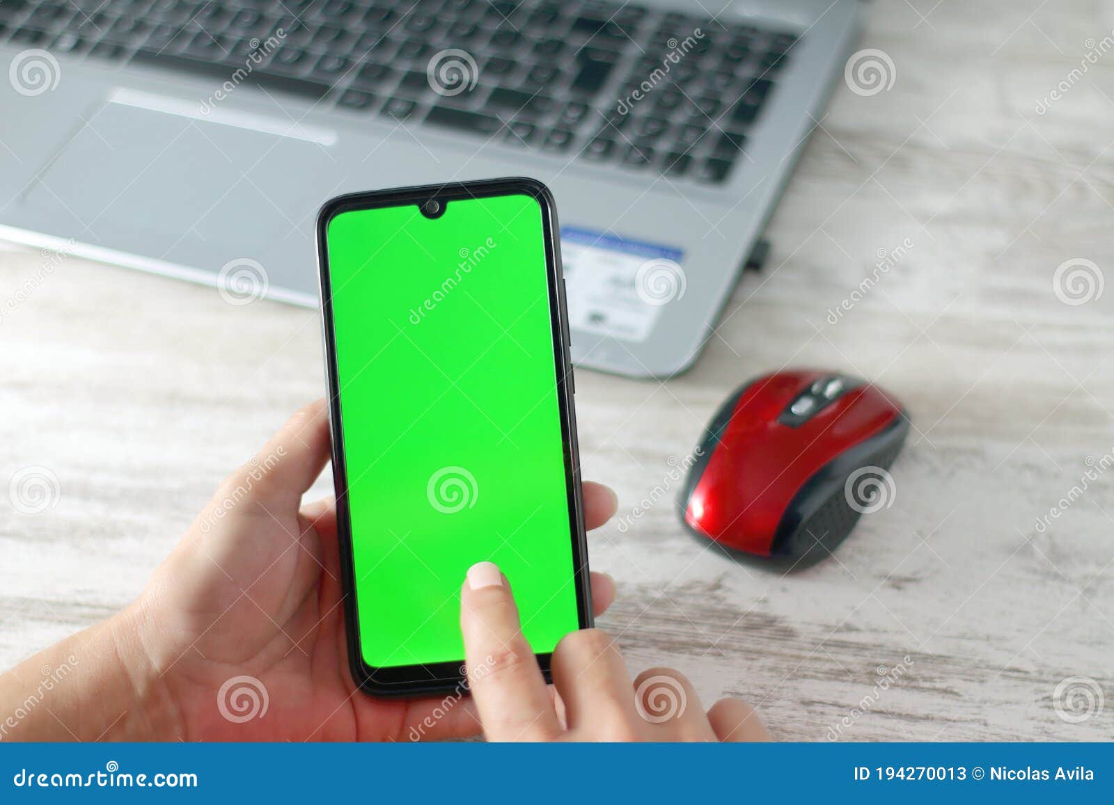 smartphone with green screen and finger on it