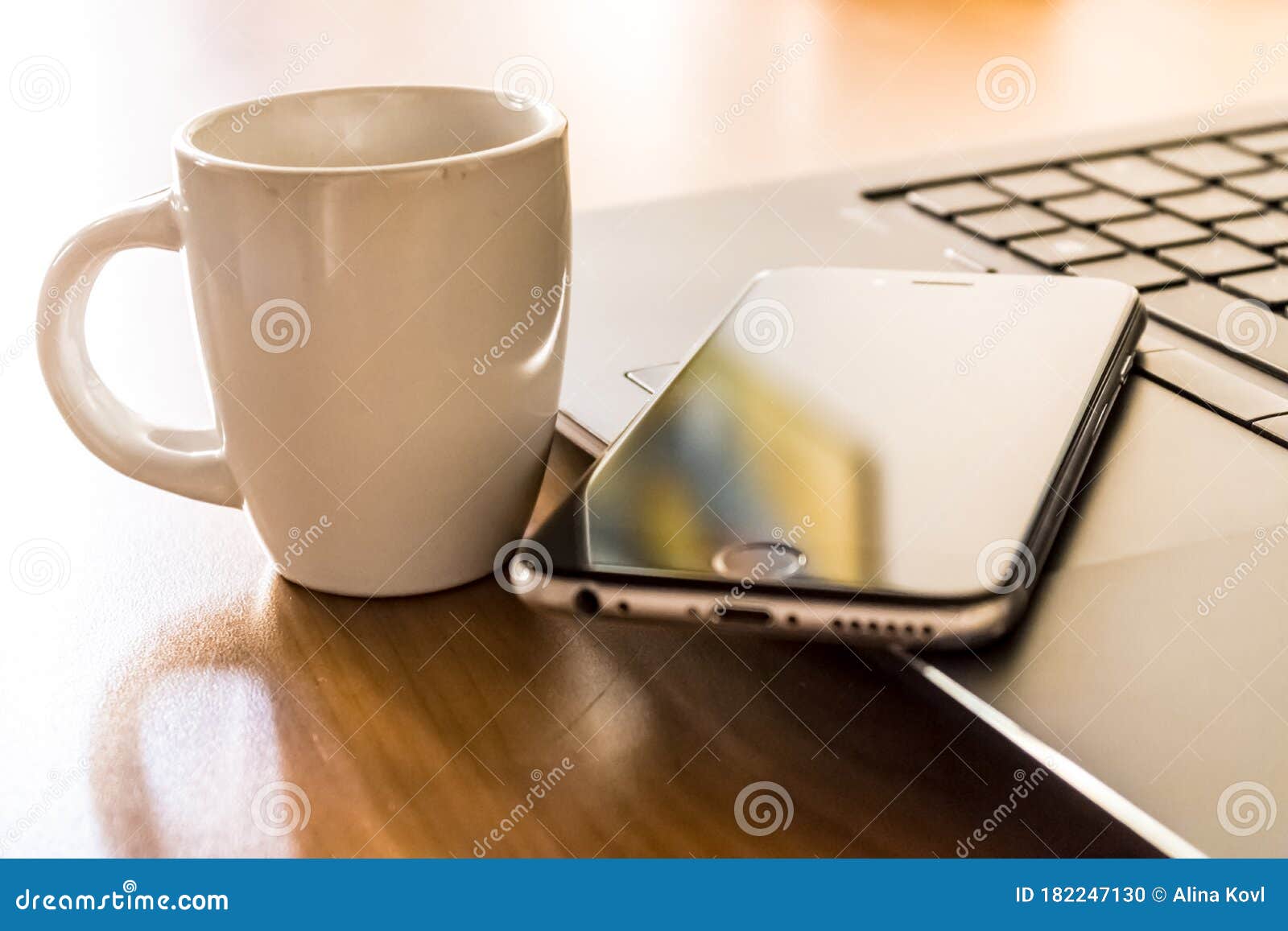 smartphone and laptop with a coffee cup, working remotely during coronavirus, smartwork with pc and cell phone concept