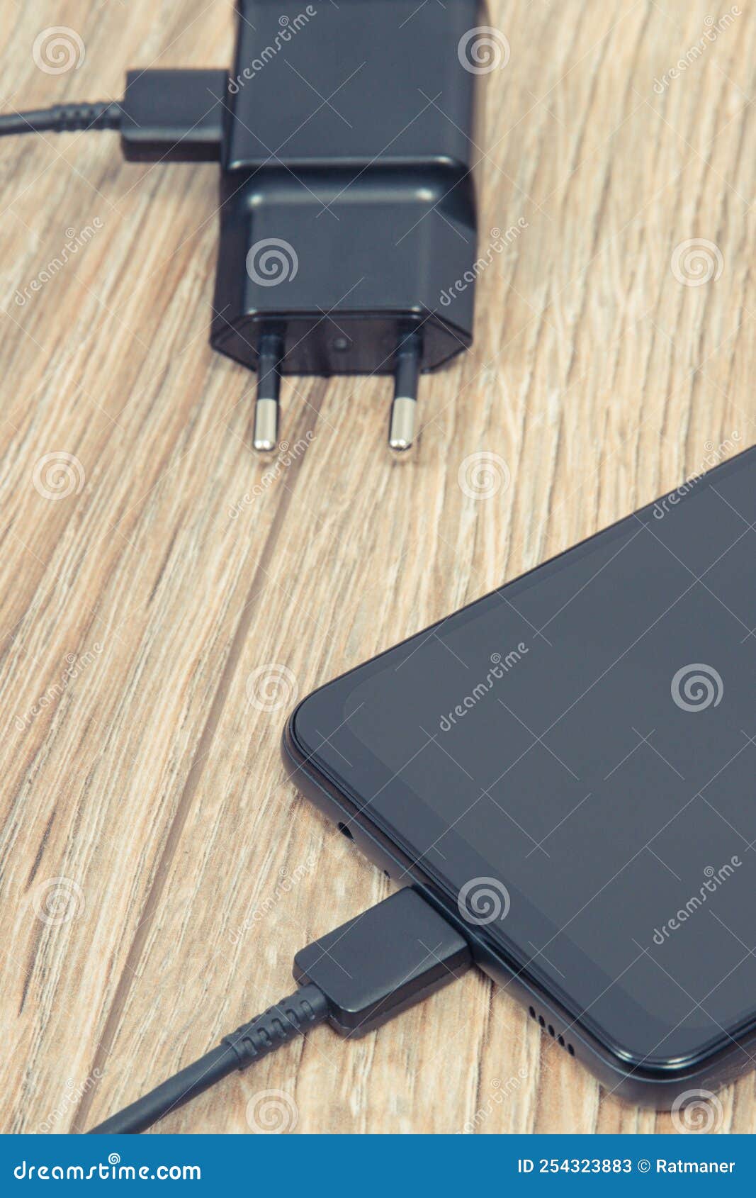 Smartphone and Charger Using To Charge Empty Battery. Various Devices