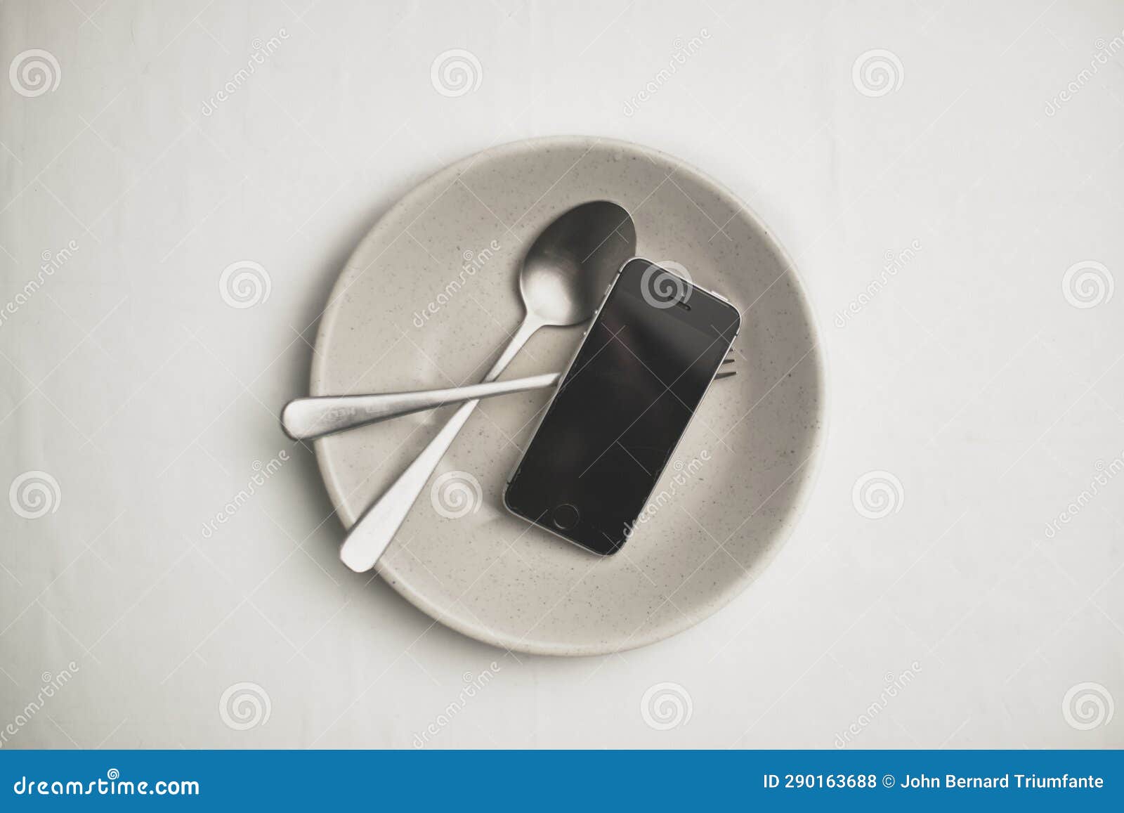 smartphone on a white plate with fork and knife. food delivery concept, top view, copy space. white background high key