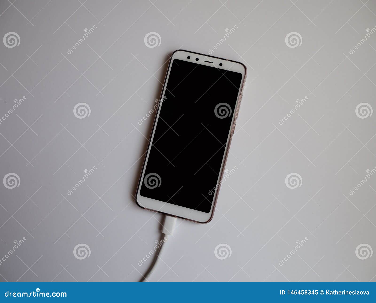 A Smartphone with a White USB Cable Stock Image Image of technology