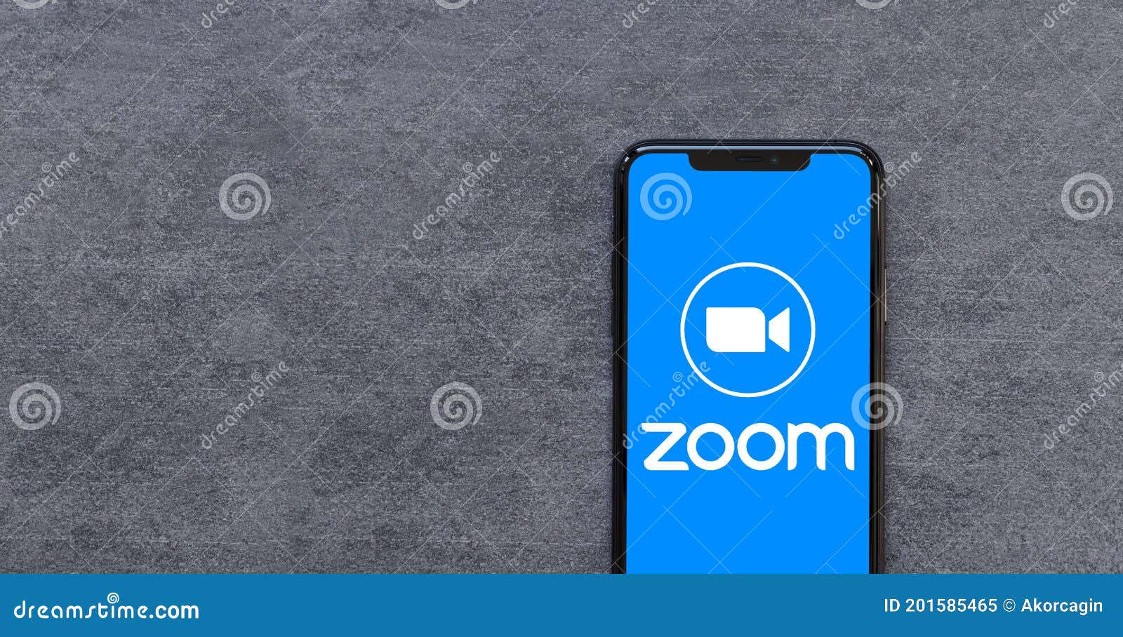Smartphone with Zoom App Logo Work Remote Concept on Natural Stone