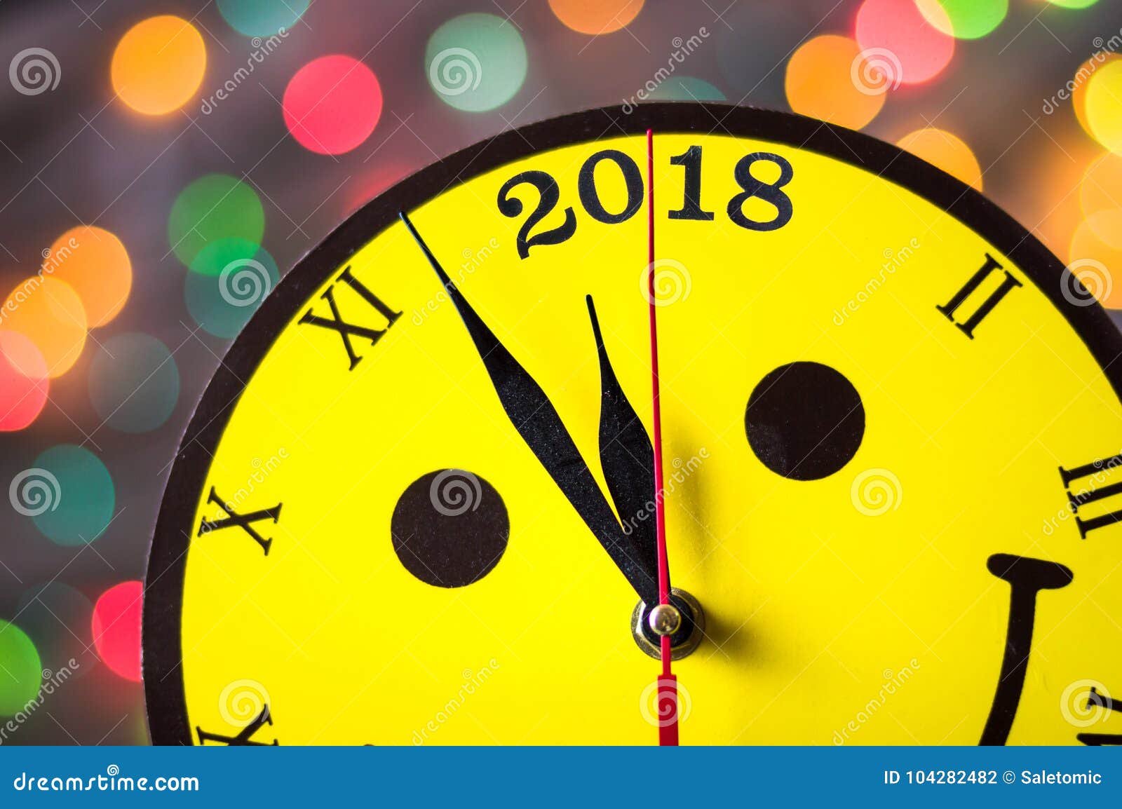 Smiley face clock approaching year 2018th and Christmas lights background