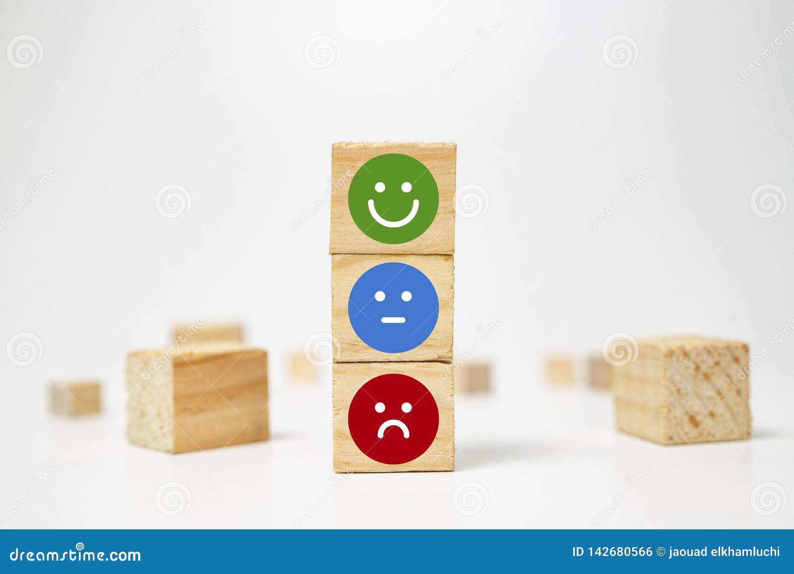 smiley face on wood block cube - business services rating customer experience, satisfaction survey concept - feedback