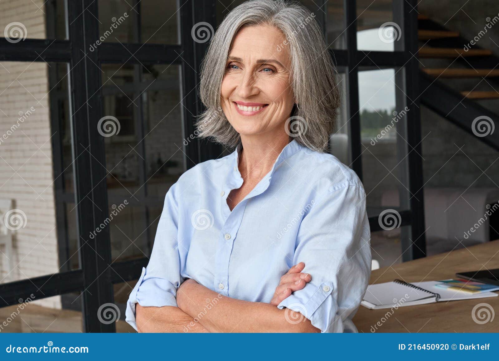 portrait of smiling business woman standing in home office.