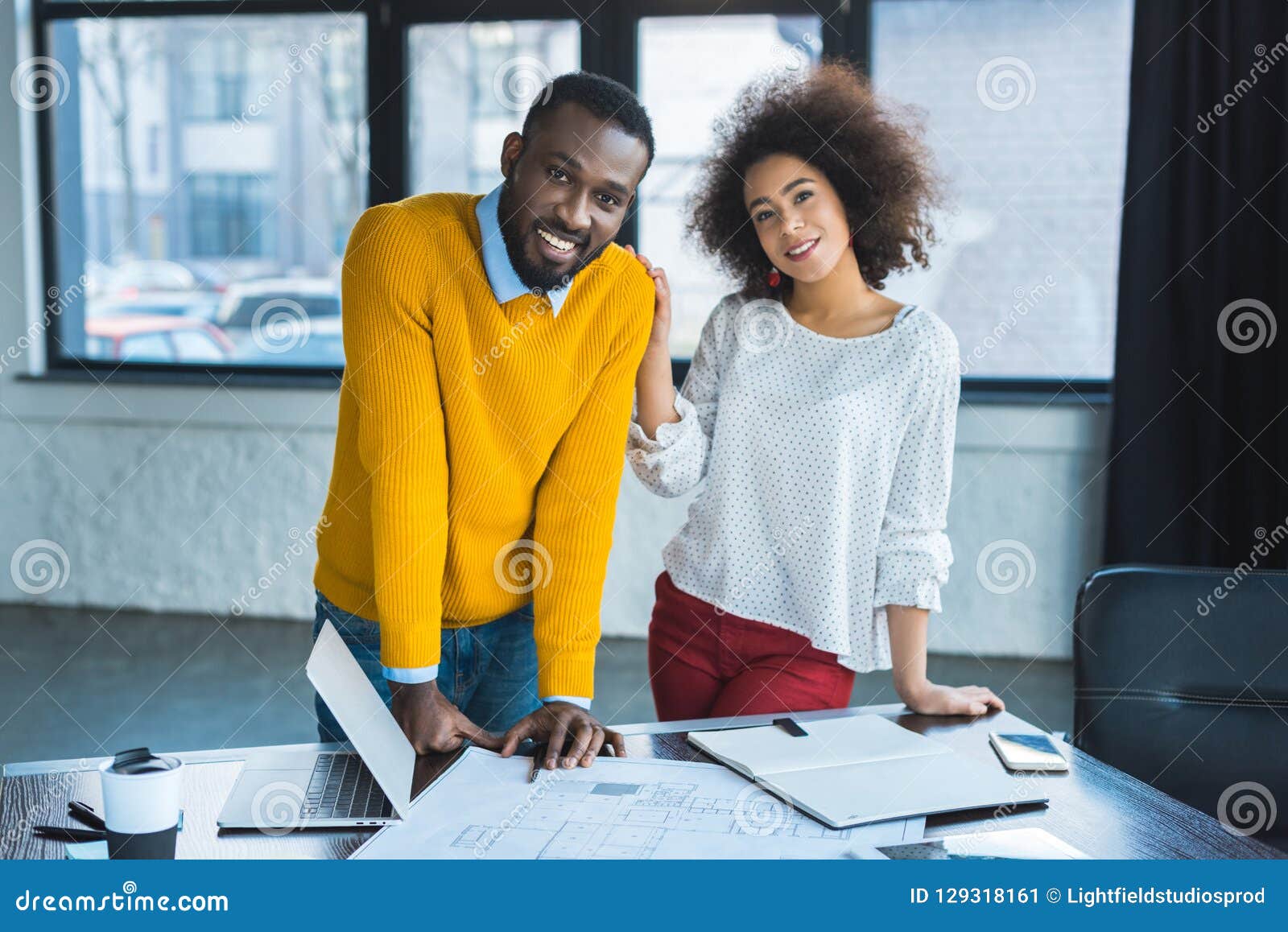 smiling african american businesspeople looking