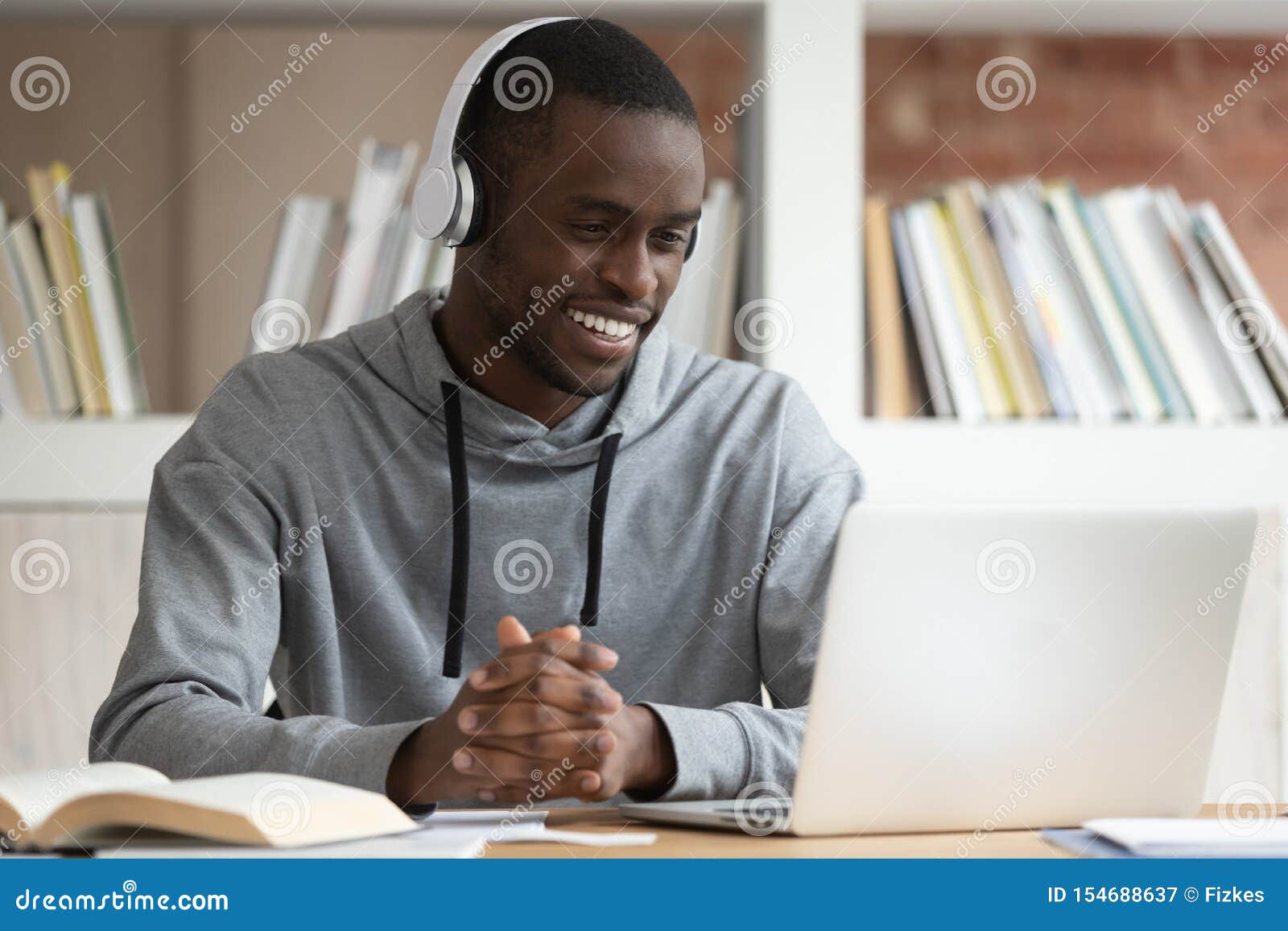 smiling black male watch online training course at laptop