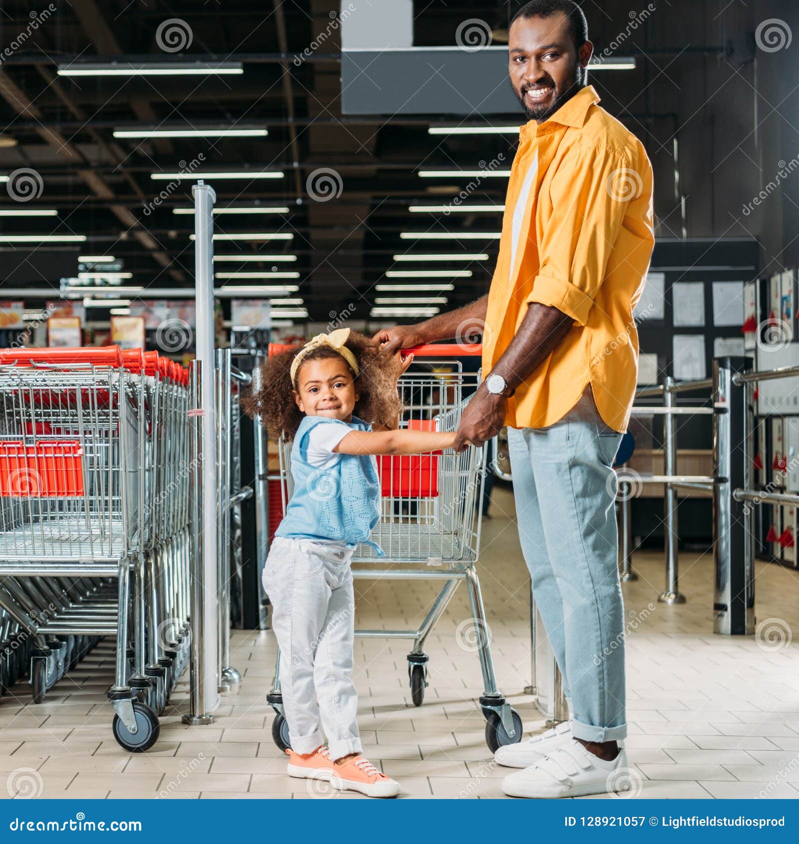 Smiling African American Man Standing with Daughter Near Shopping ...