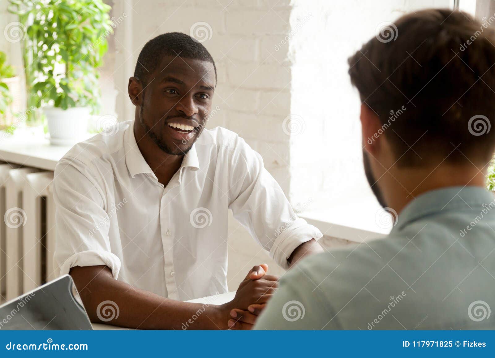colleagues having conversation chatting at workplace