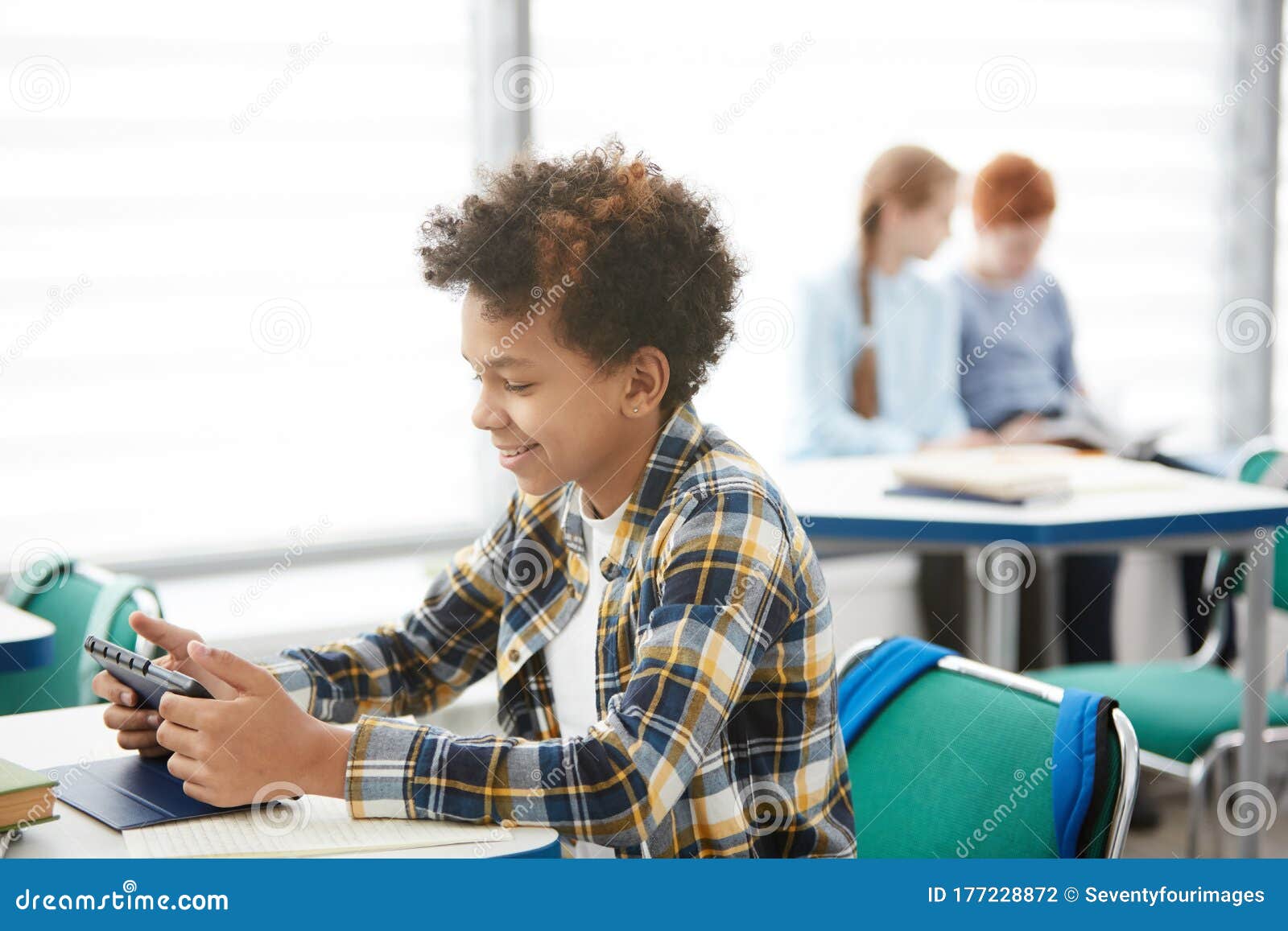 Smiling African Boy Playing Online Games in Class Stock Photo - Image of  phone, modern: 177228872