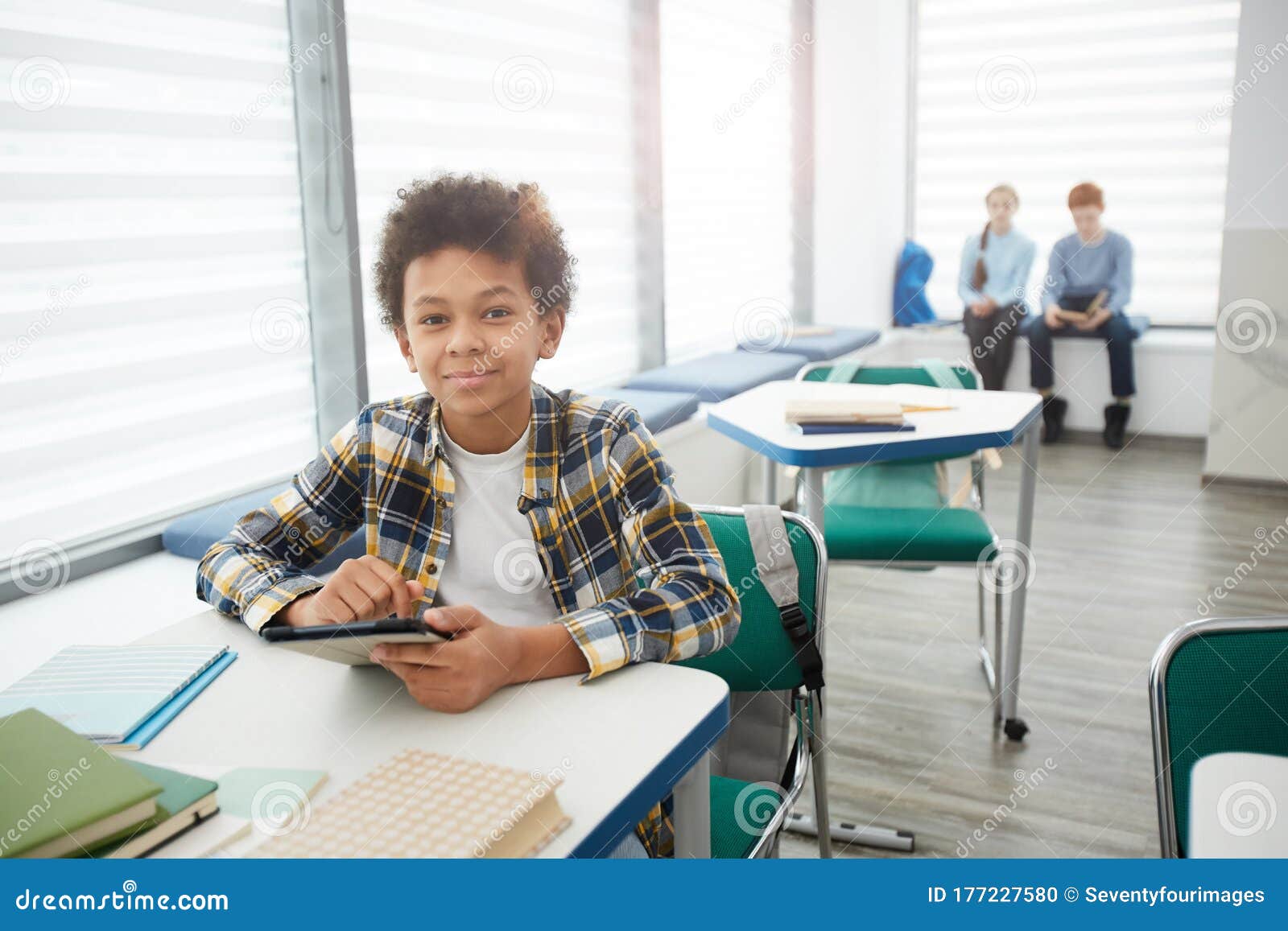 Smiling African Boy Playing Online Games in Class Stock Photo - Image of  phone, modern: 177228872