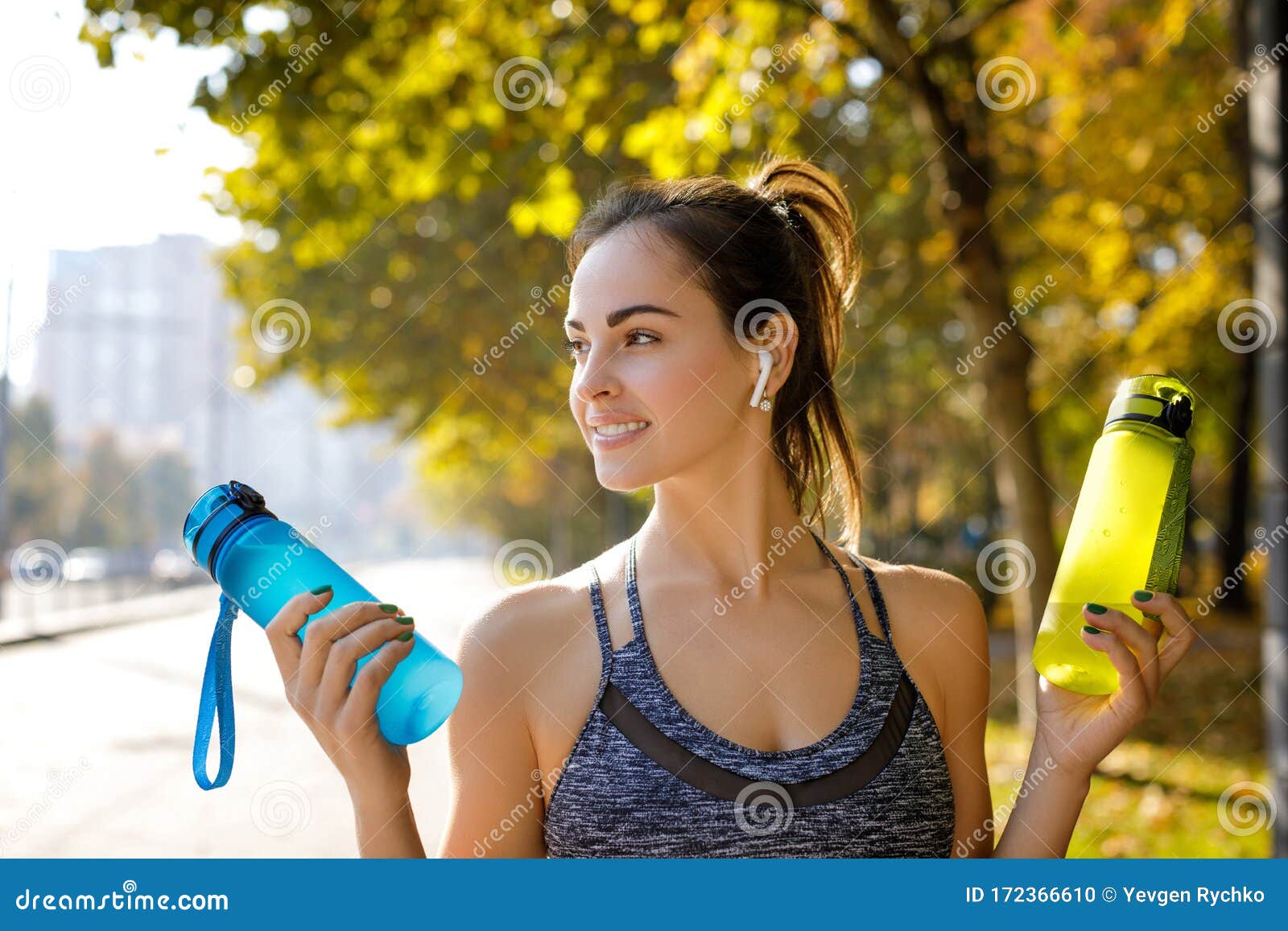 Smiling Athletic Woman Holding Two Bottles of Water Stock Photo - Image ...