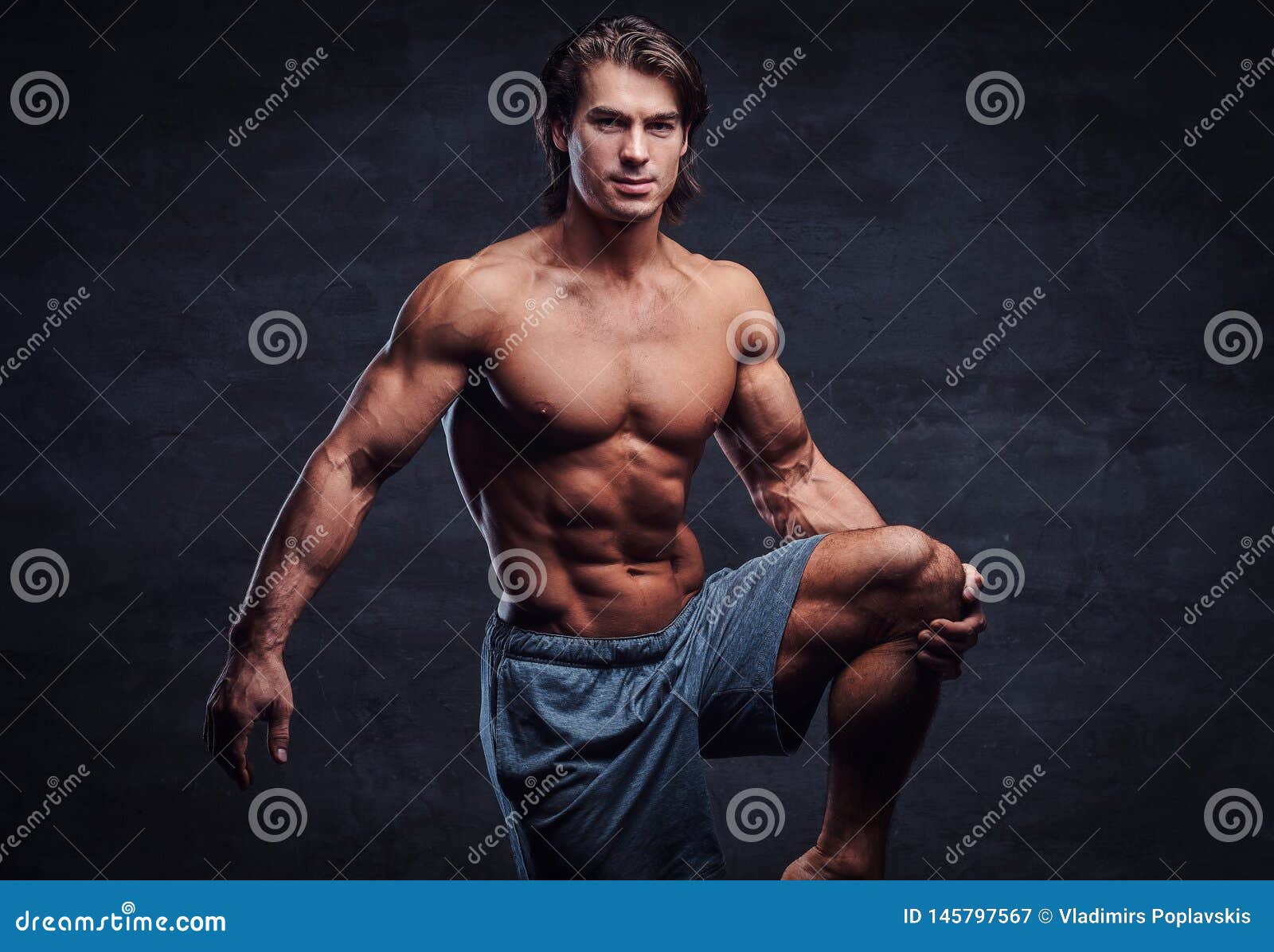Young Attractive Bodybuilder With Naked Torso Is Posing 