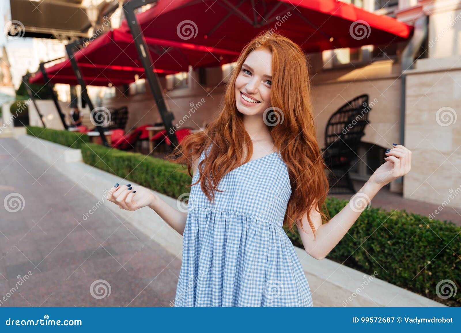 Smiling Attractive Redhead Girl With Long Hair Posing