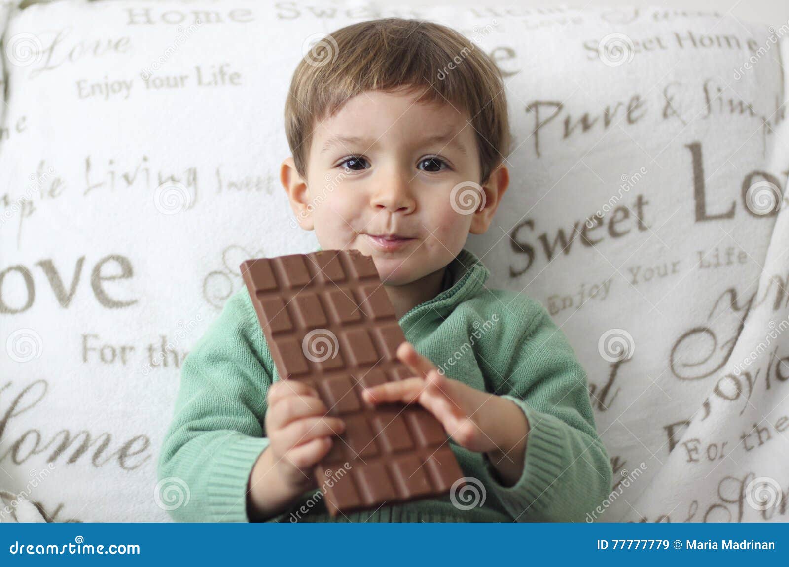 Smiling Baby Eating a Chocolate Tablet Stock Image Image of people