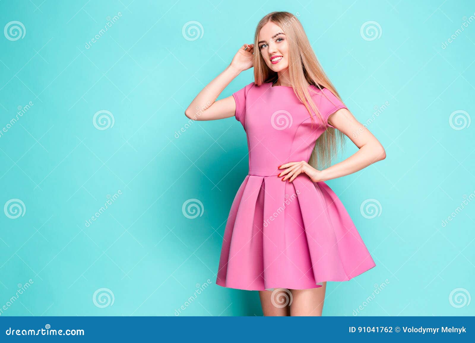 Smiling Beautiful Young Woman in Pink Mini Dress Posing at Studio Stock ...