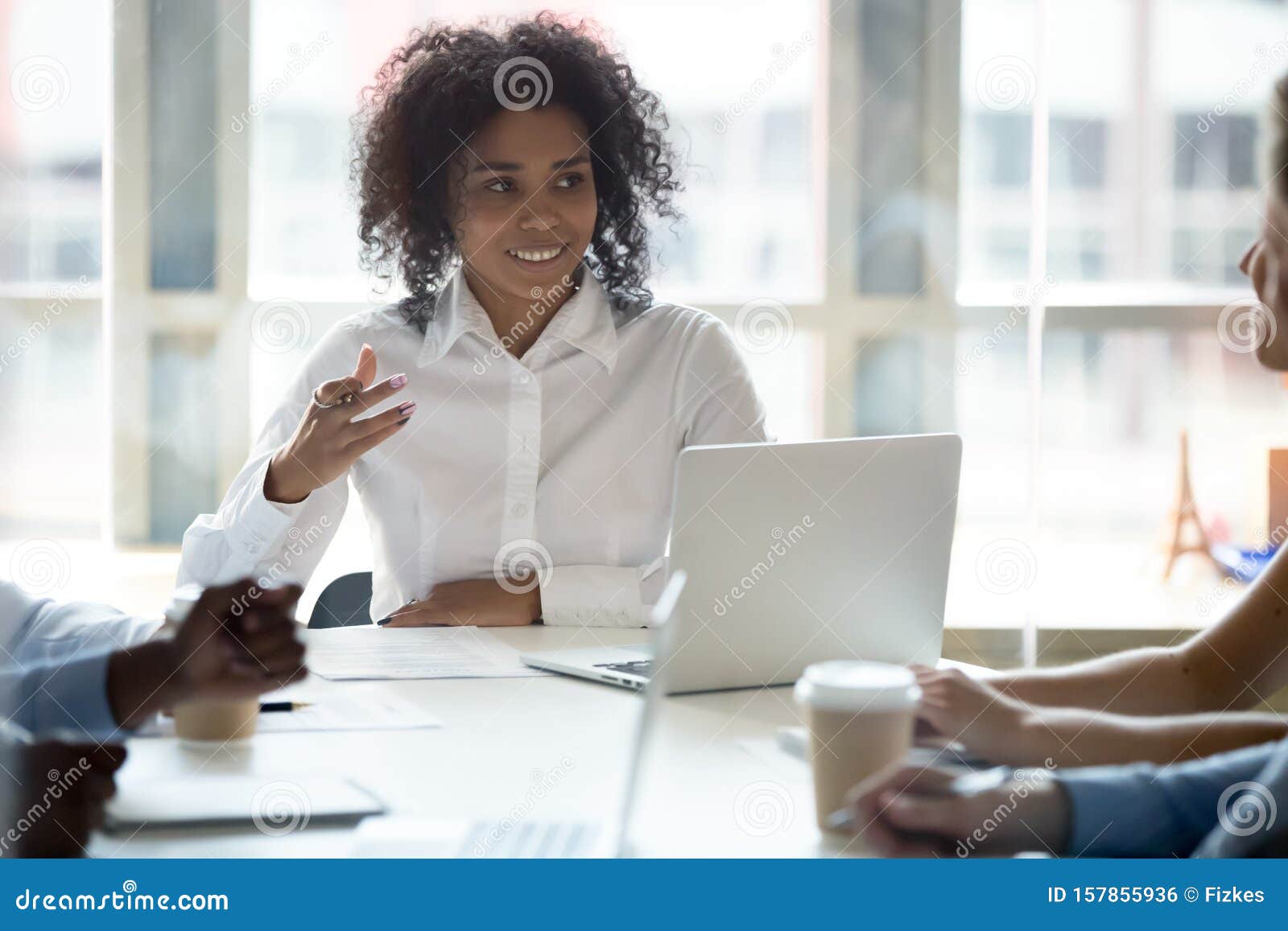 smiling black businesswoman talk sharing ideas at company briefing