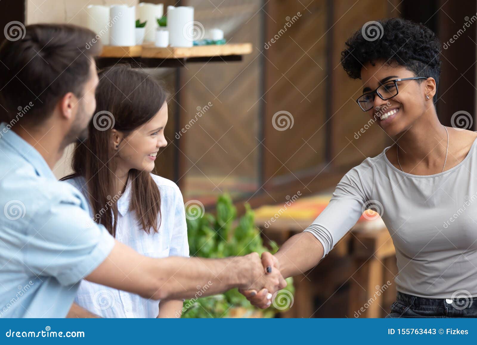 happy couple handshake female specialist at meeting
