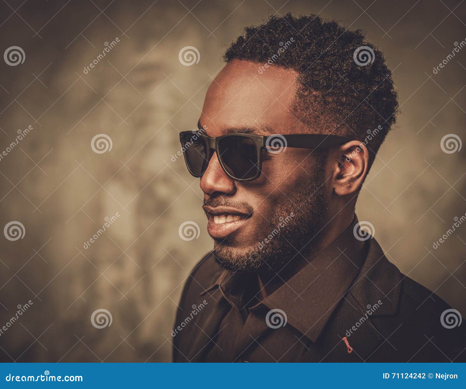 Smiling Black Man With Sunglasses Posing On Dark Background. Stock
