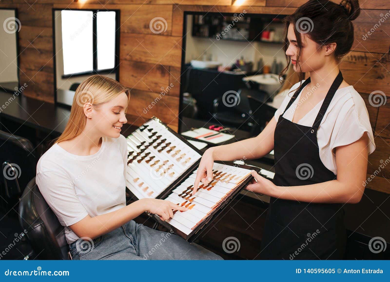 Smiling Blonde Young Woman And Hairdresser Choosing Hair Color