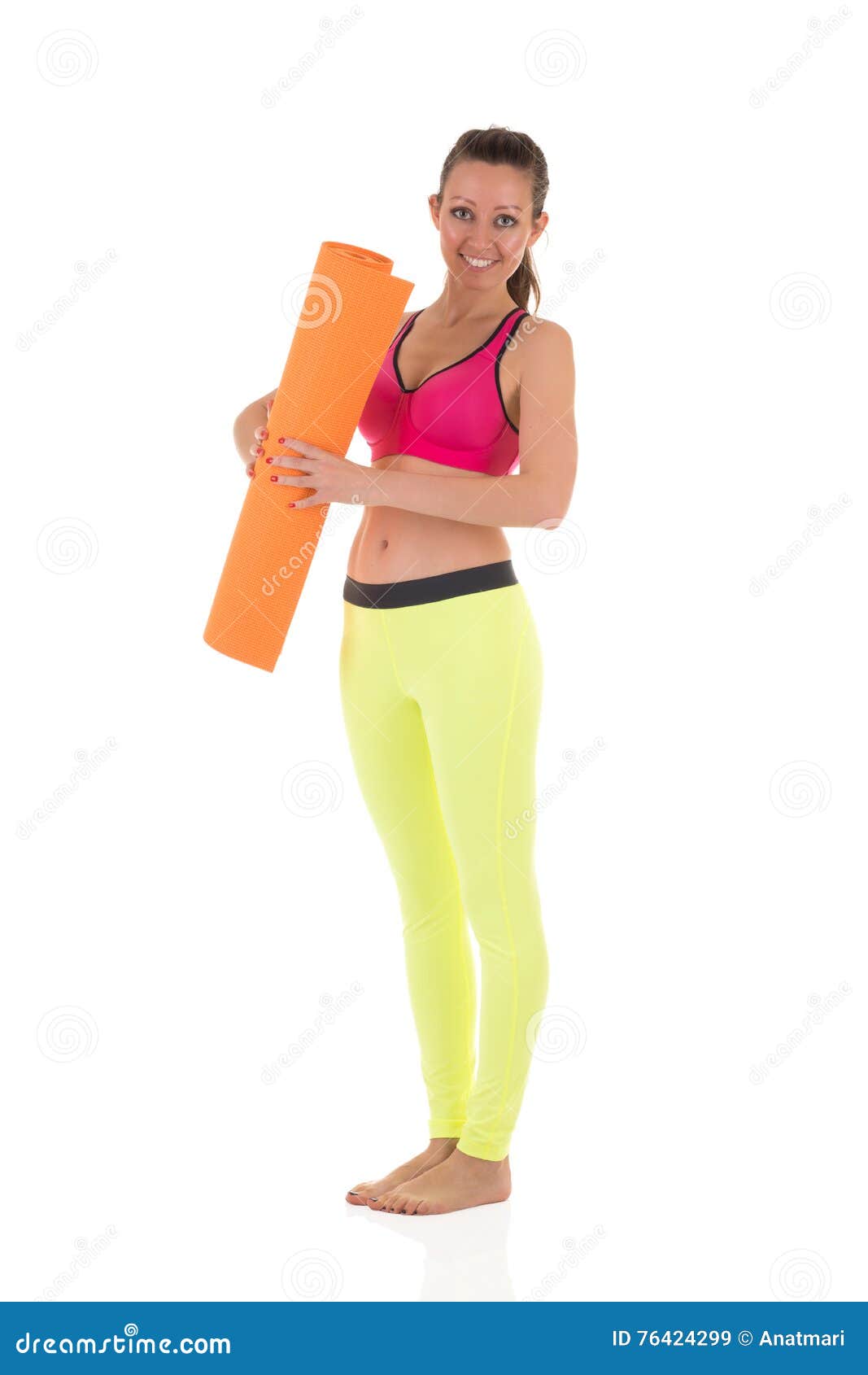 Smiling Brunette Woman In Sports Neon Yellow Leggings And Pink Bra Standing With The Orange