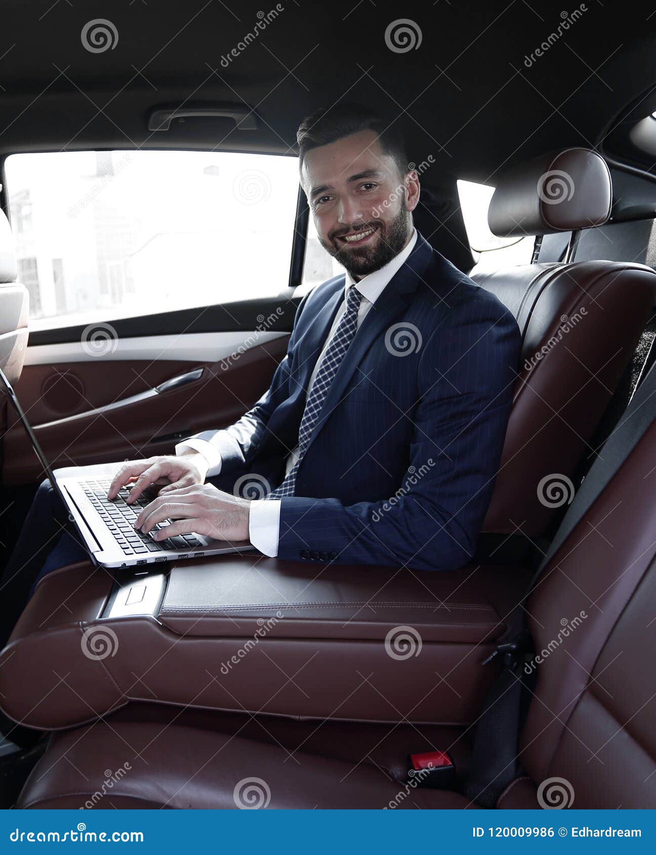 Smiling Businessman Sitting In The Back Seat Of A Prestigious Car Stock