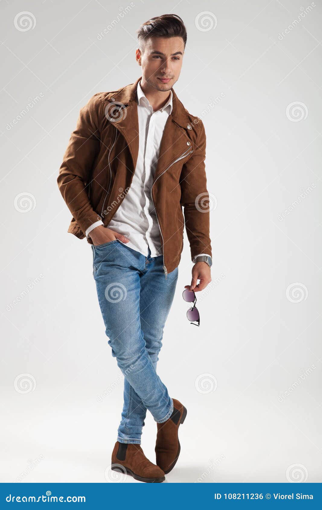 Smiling Casual Man Holding Sunglasses and Standing Stock Photo - Image ...