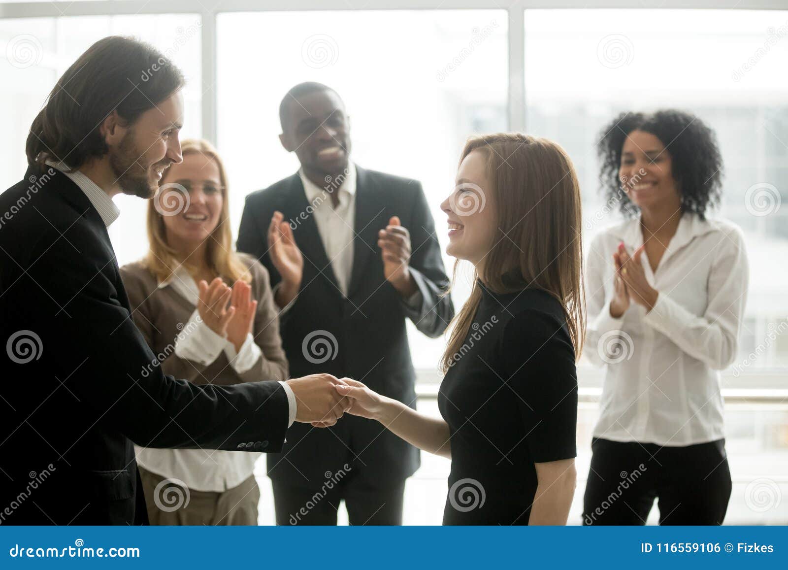 smiling ceo handshaking successful female worker showing respect