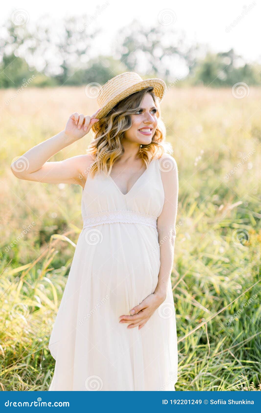 Smiling Charming Young Pregnant Woman, Wearing White Dress and Straw ...