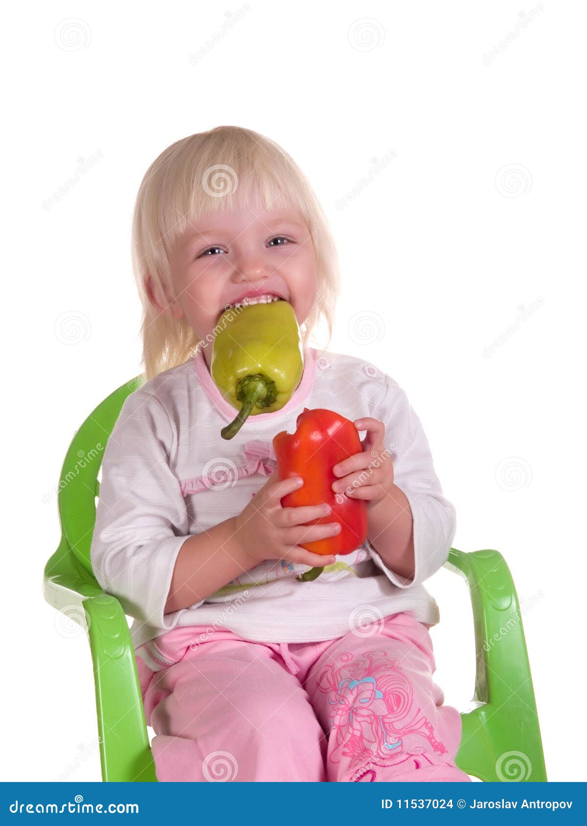 Smiling child eats pepper stock photo. Image of happiness 11537024