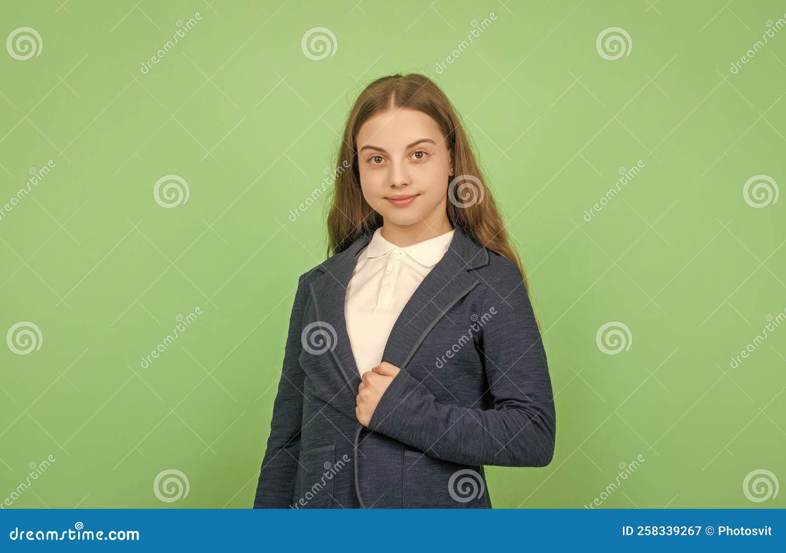 Smiling Child in School Uniform on Green Background, School Stock Image
