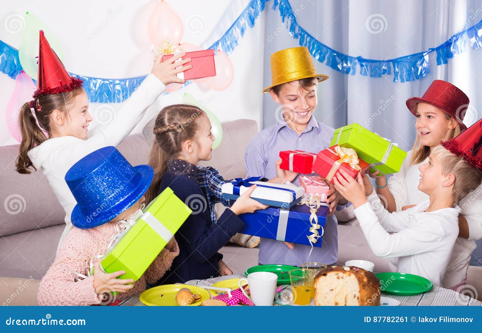 Smiling Children Handing Gifts To Birthday Boy Stock Image - Image of ...