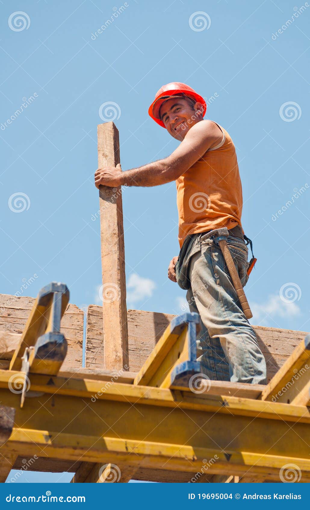 smiling construction worker with formwork beam