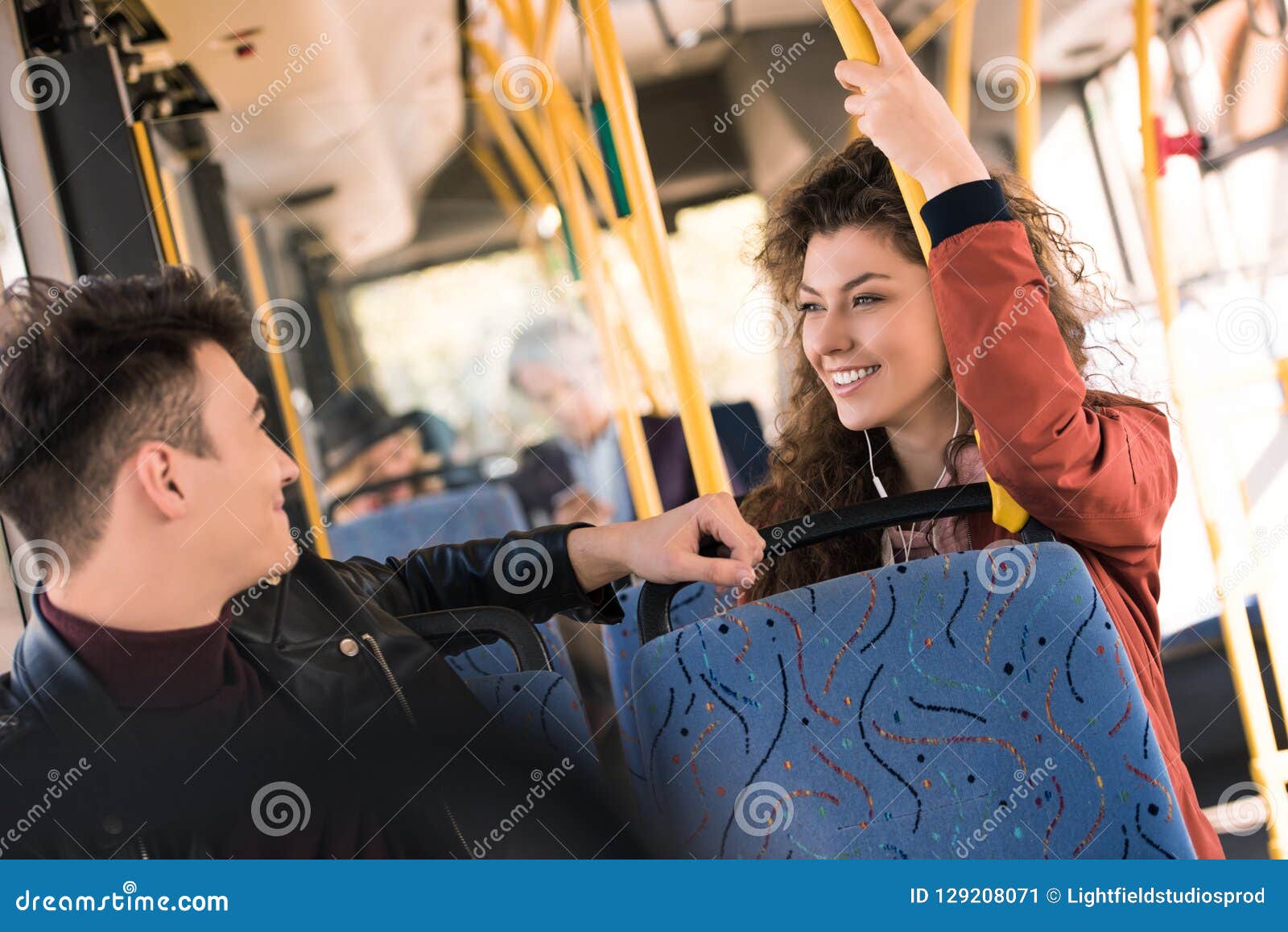 cheerful young man and woman smiling each other