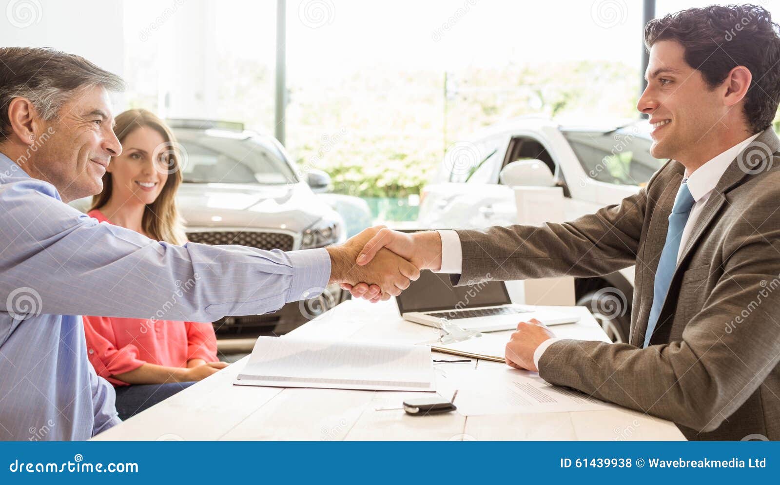 smiling couple buying a new car