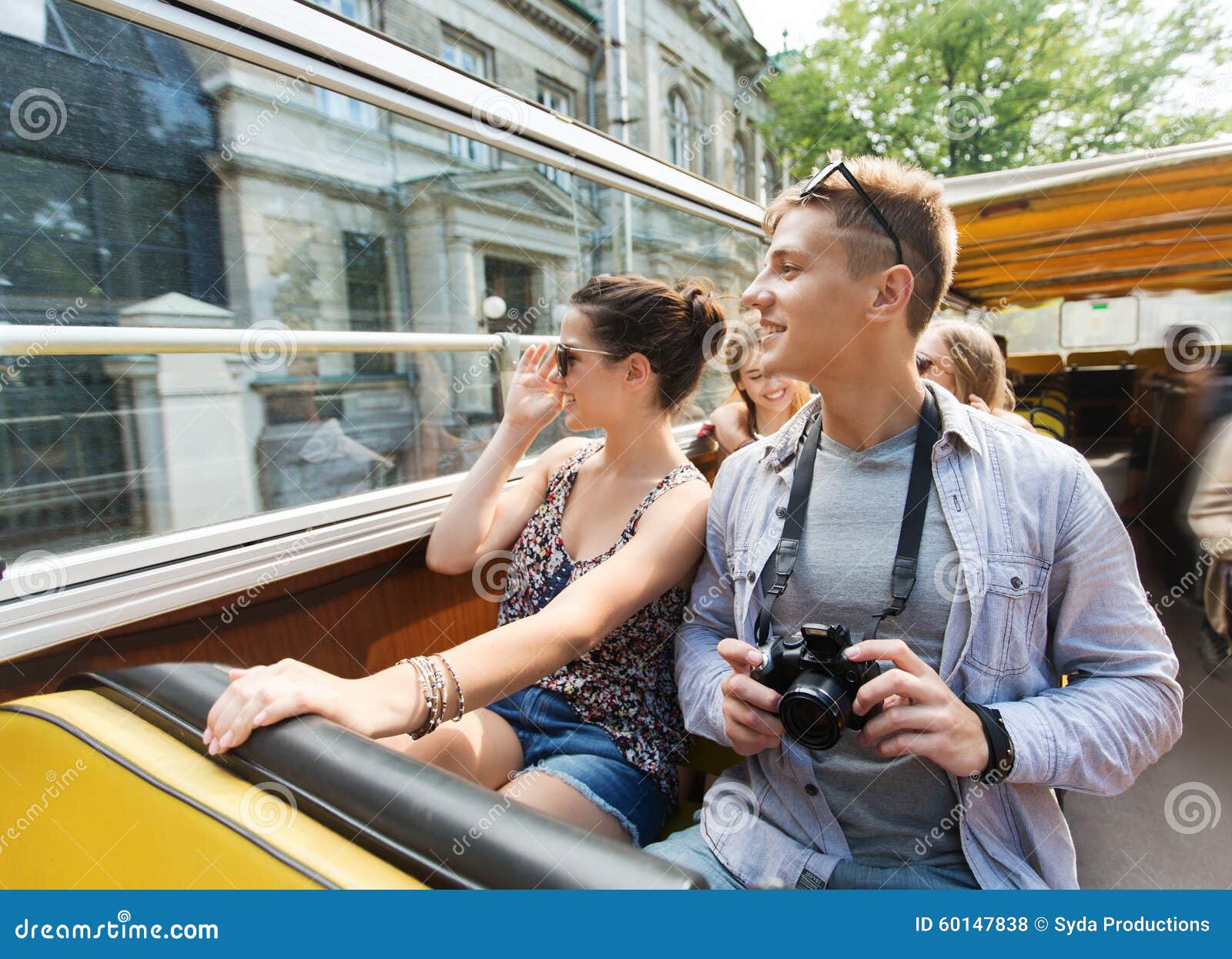 Smiling Couple With Camera Traveling By Tour Bus Stock