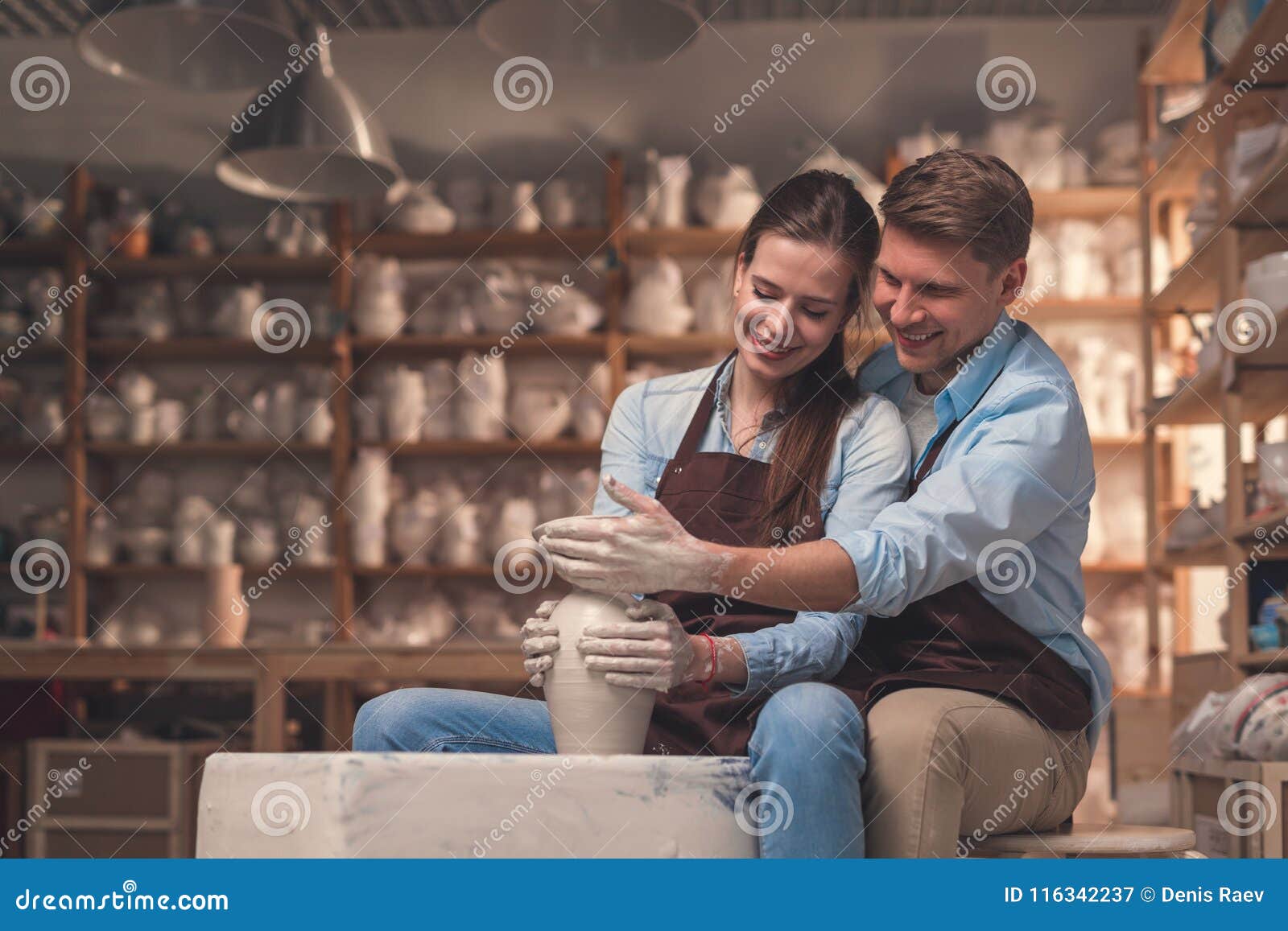 Smiling couple in pottery stock image. Image of romantic 116342237