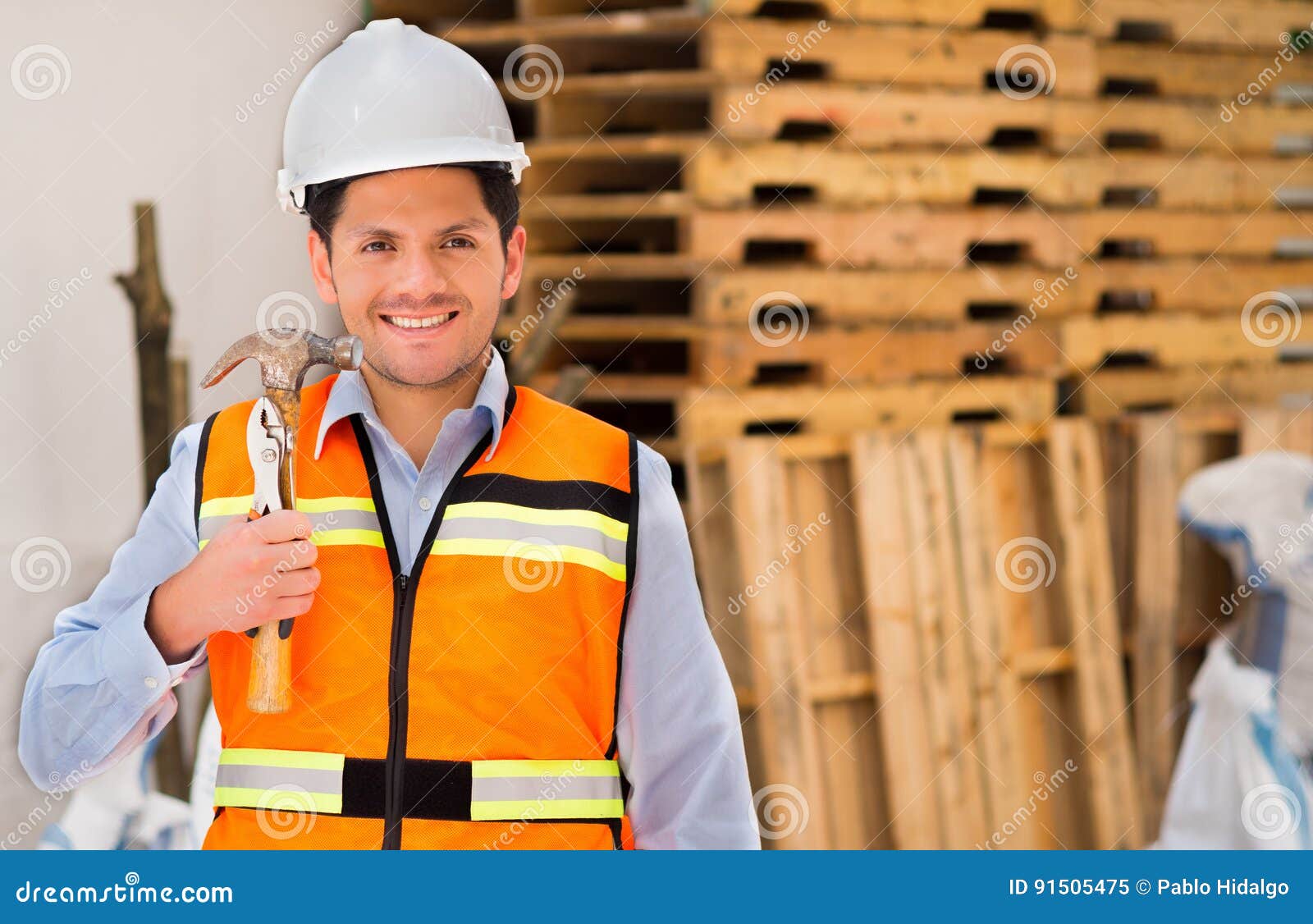Smiling Engineer while Holding a Construction Accessories at