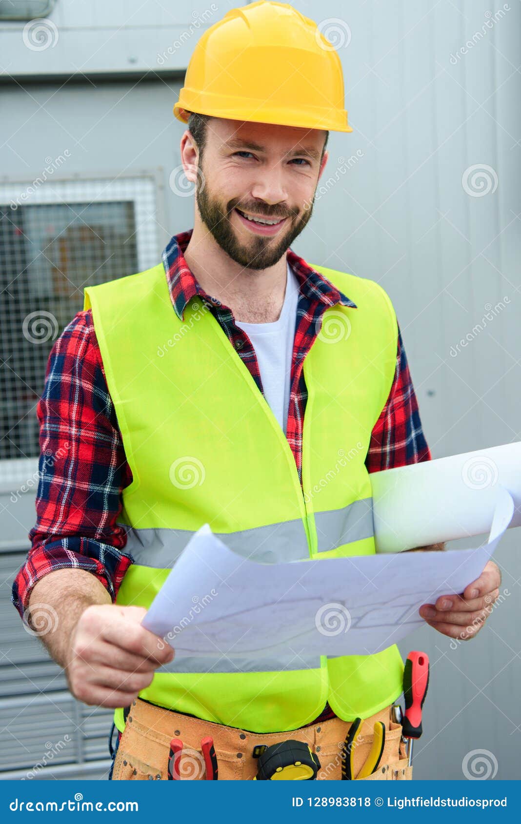 Smiling Engineer in Safety Vest and Helmet Working Stock Photo Image
