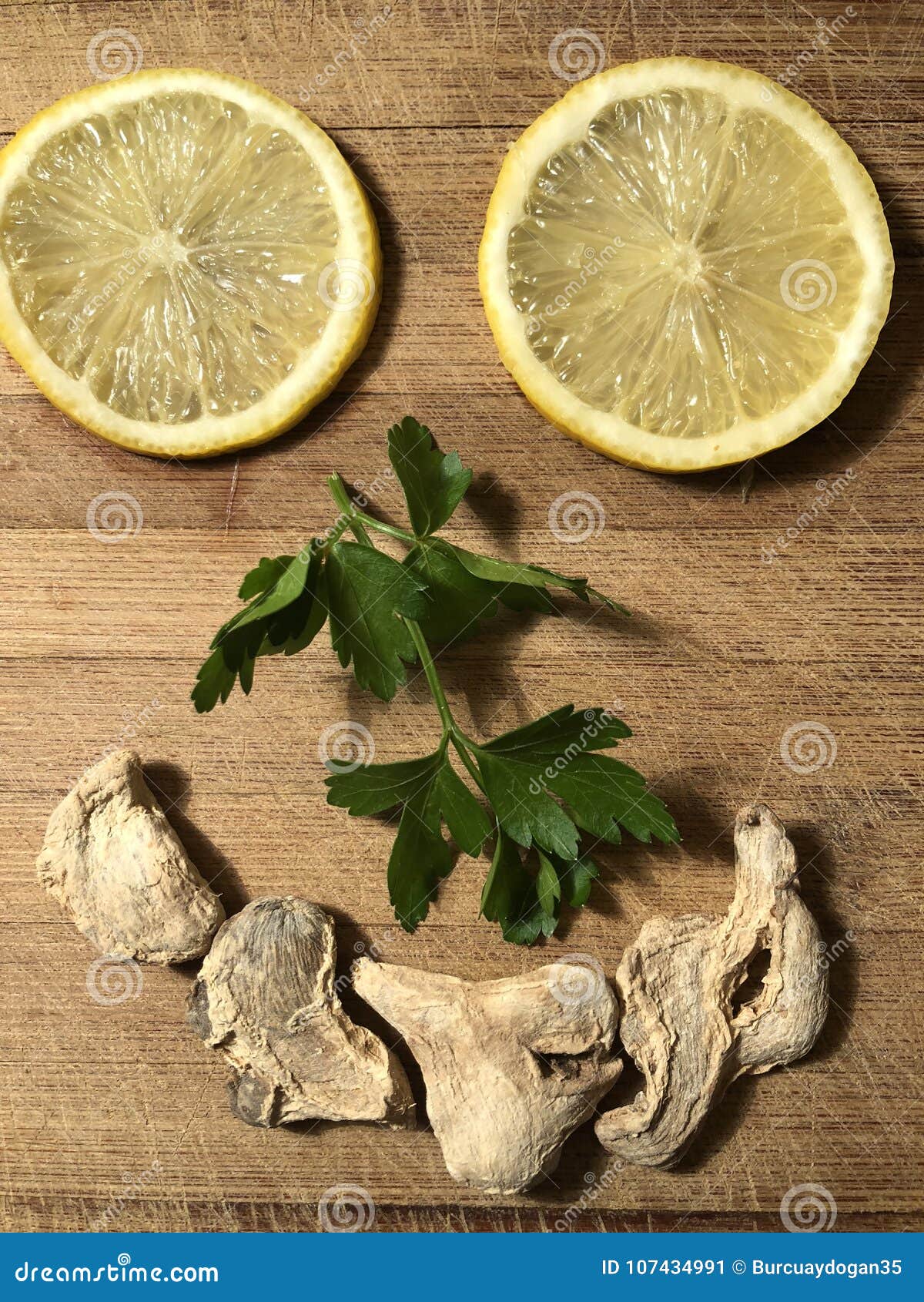 smiling face made from lemon slices, parsley and dried ginger