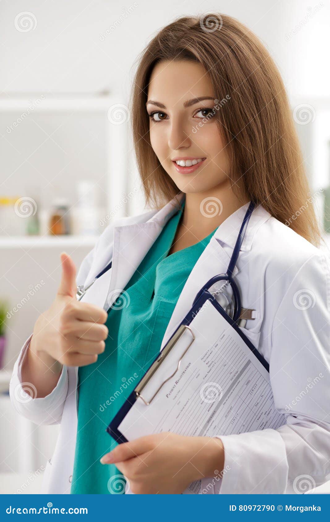 smiling female doctor showing thumb up