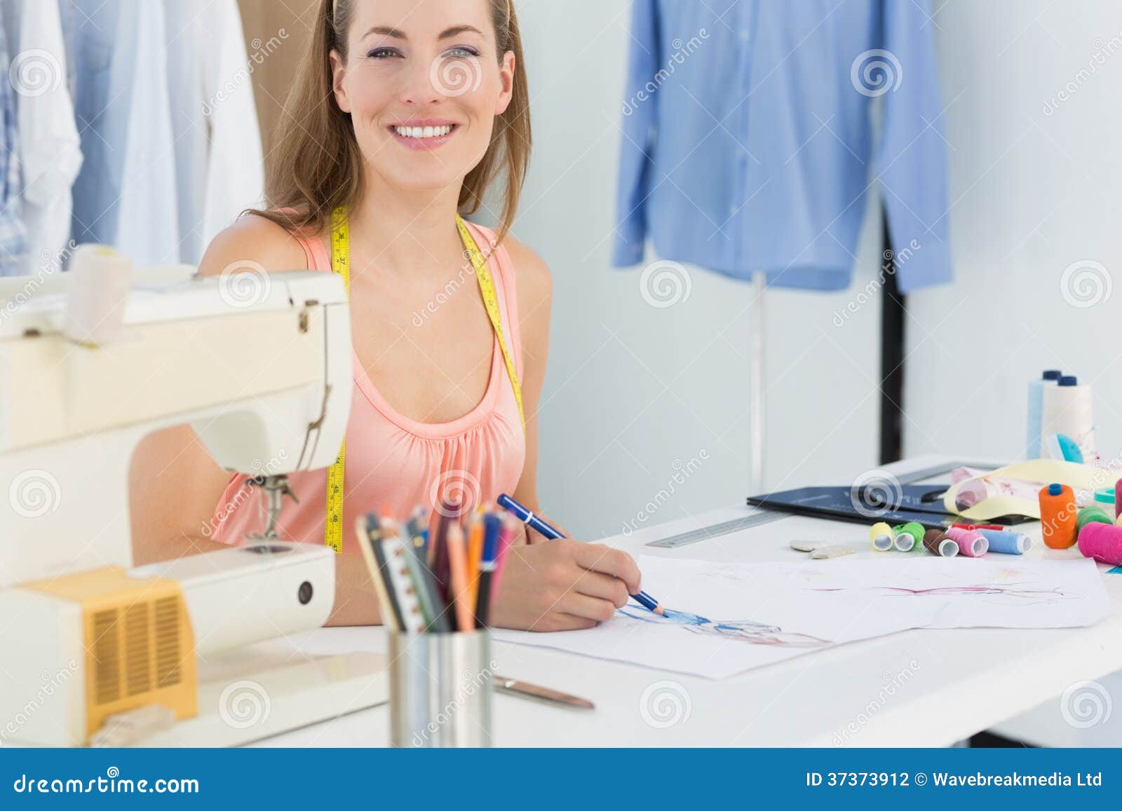Smiling Female Fashion Designer Working on Her Designs Stock Photo ...