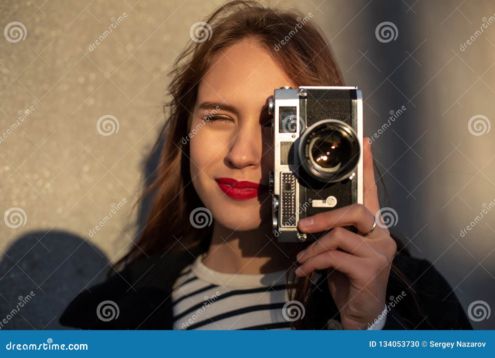 Smiling Female Photographer in Jacket Standing in Front of Wall Ready ...