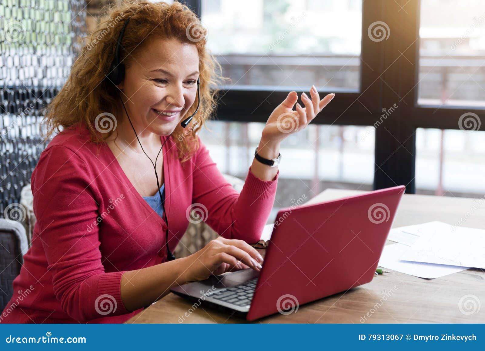 smiling ginger woman talking per skype