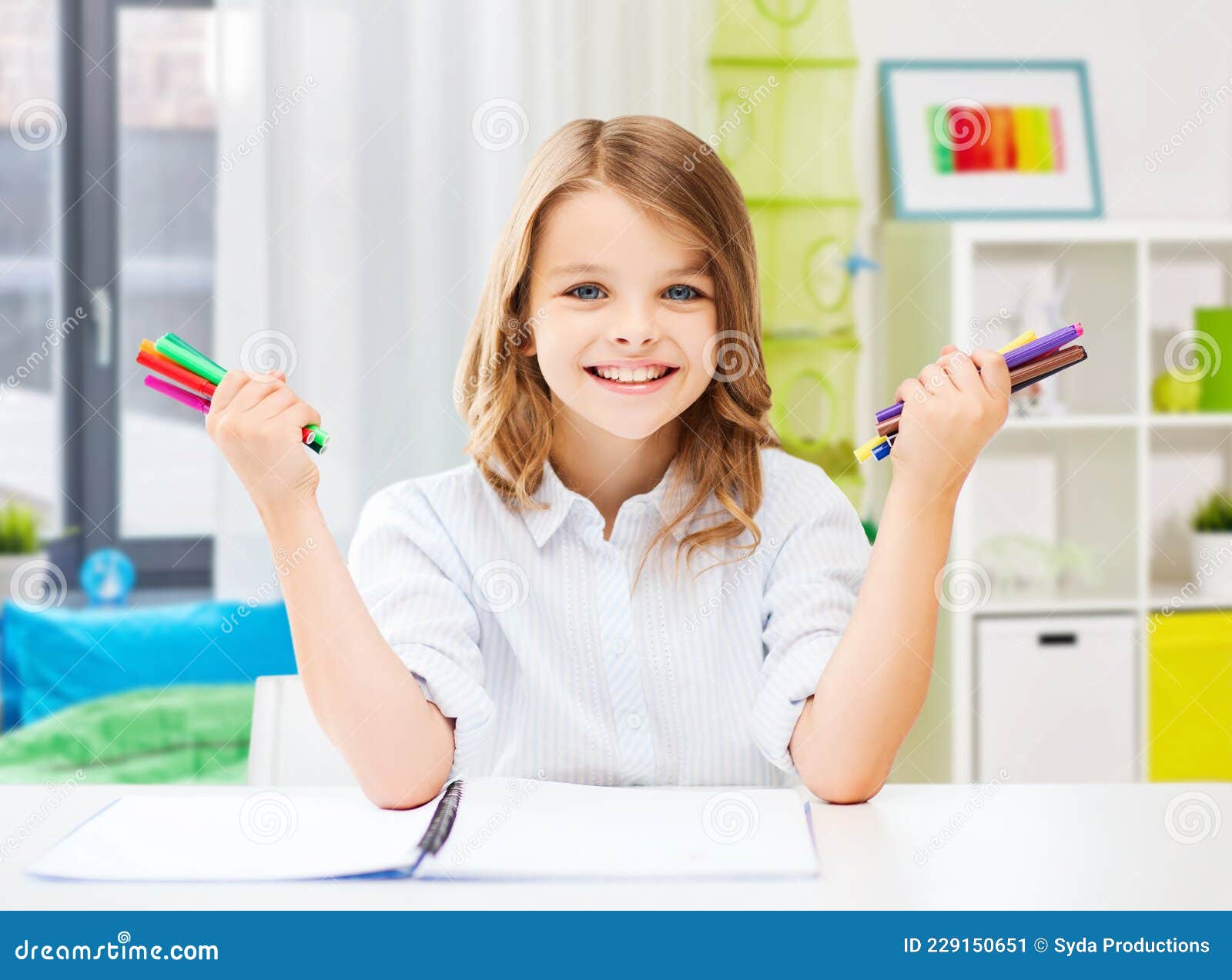 smiling girl with colorful felt-tip pens at home