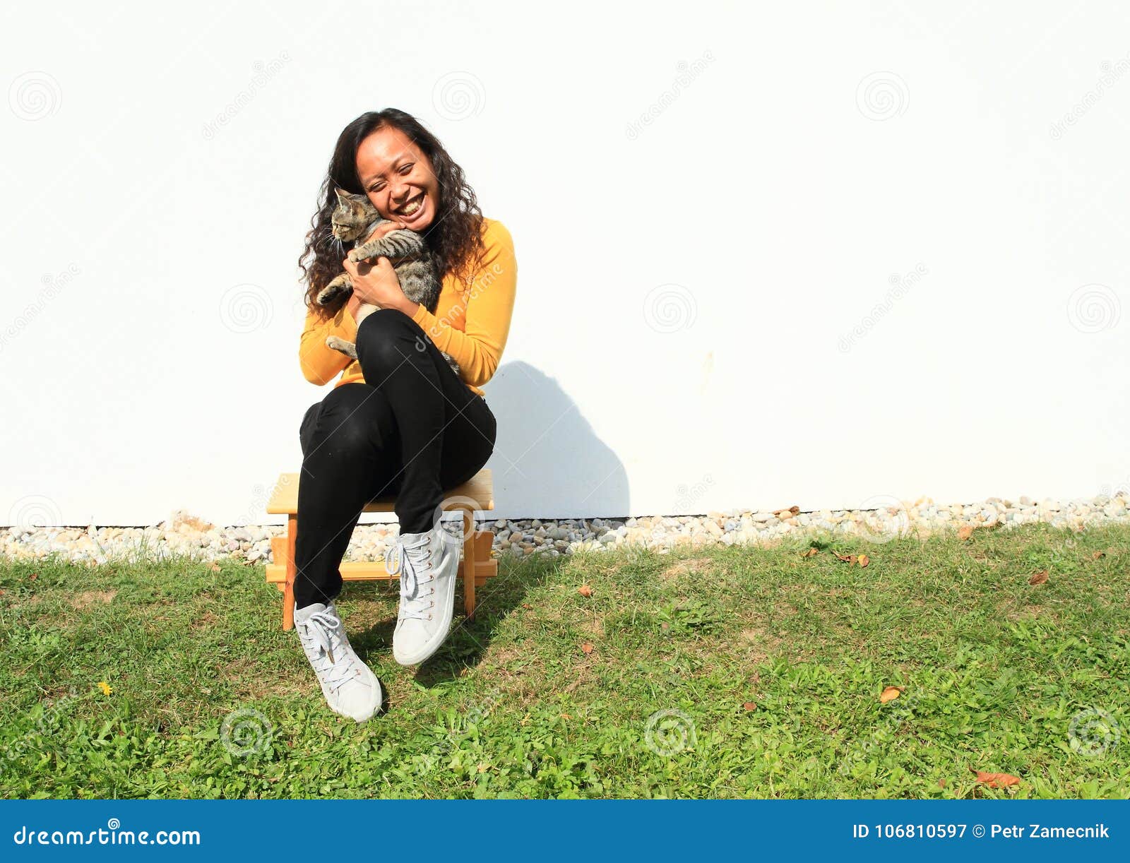 Smiling girl hugging a cat stock image ...