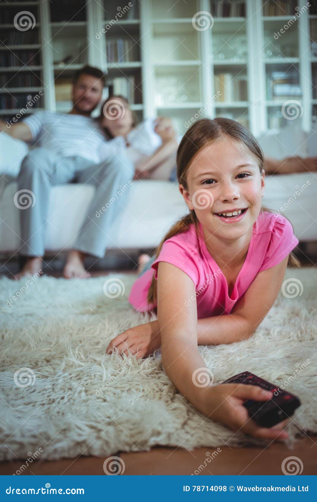 Smiling Girl Lying on Rug and Changing Channels Stock Photo Image of domicile, lifestyle 78714098