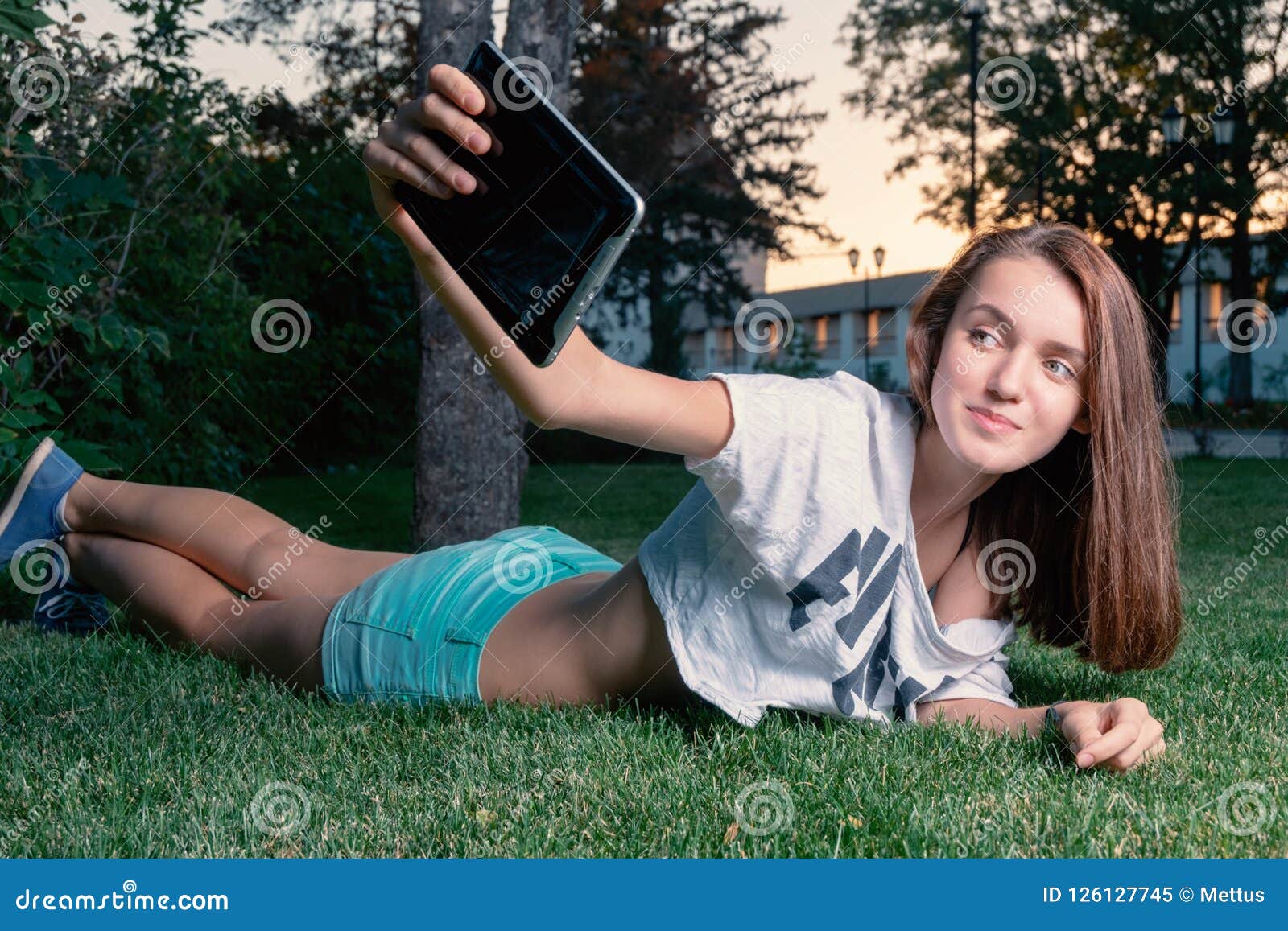 Happy Girl Make Selfie While Lying Down On Park Grass Summertime Fun